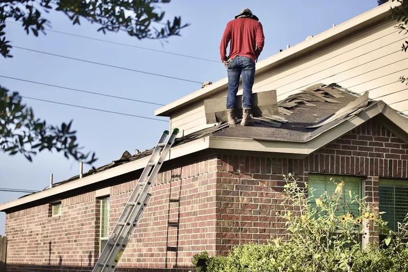 Professional roofer working on a residential roof in Westcotville